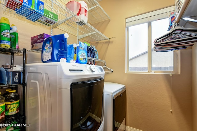 clothes washing area with a wealth of natural light, laundry area, and independent washer and dryer