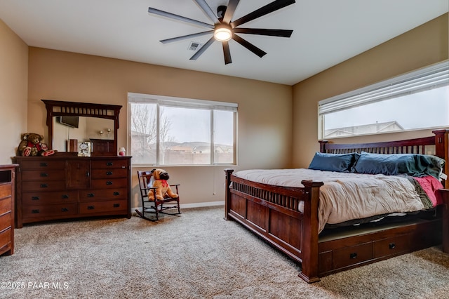 carpeted bedroom featuring visible vents, ceiling fan, and baseboards