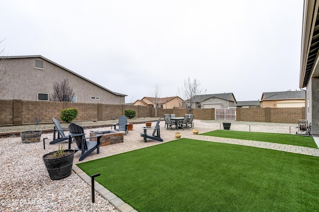 view of yard featuring a fire pit, a patio, and a fenced backyard