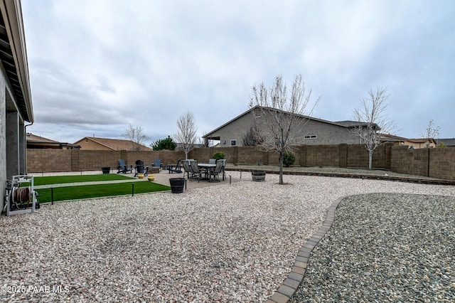 view of yard featuring a patio area and a fenced backyard