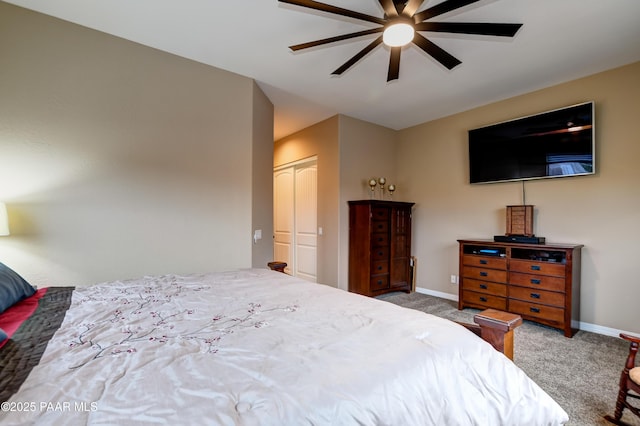 carpeted bedroom featuring a closet, ceiling fan, and baseboards