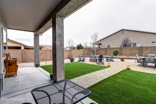 exterior space featuring a fenced backyard and a fire pit