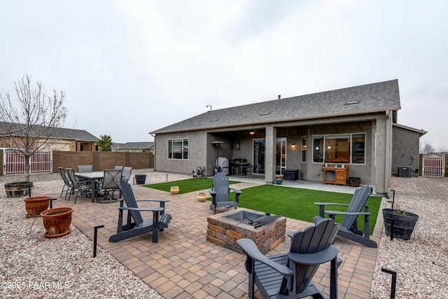 view of patio featuring an outdoor fire pit, a fenced backyard, outdoor dining space, and central air condition unit