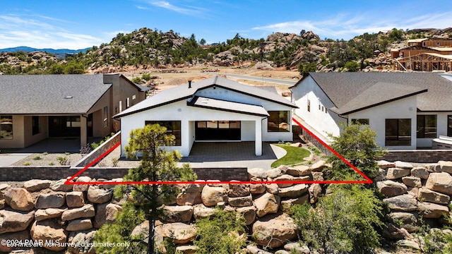 rear view of property with a patio and stucco siding