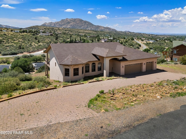 view of front facade with a mountain view and a garage