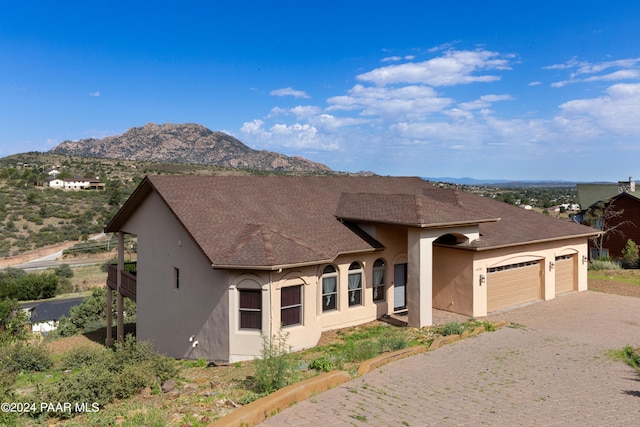 view of front of home featuring a mountain view and a garage