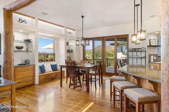 dining room with french doors, plenty of natural light, and light hardwood / wood-style floors