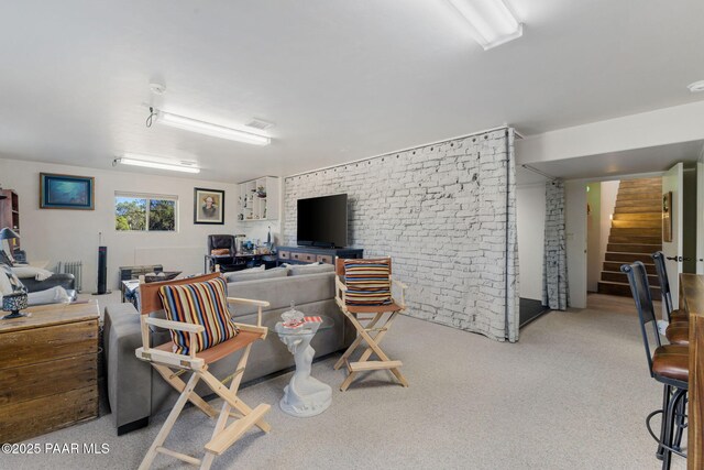 home office with radiator heating unit and brick wall