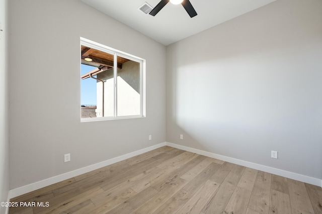 empty room with ceiling fan and light hardwood / wood-style flooring