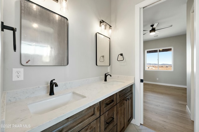 bathroom featuring hardwood / wood-style flooring, ceiling fan, and vanity