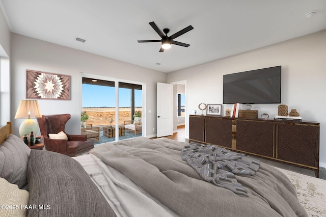 bedroom with hardwood / wood-style flooring, access to outside, and ceiling fan