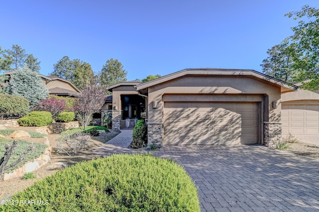 1690 Stable Rock Rd, Prescott, AZ 86303 - ranch-style house featuring stone siding, decorative driveway, stucco siding, and a garage