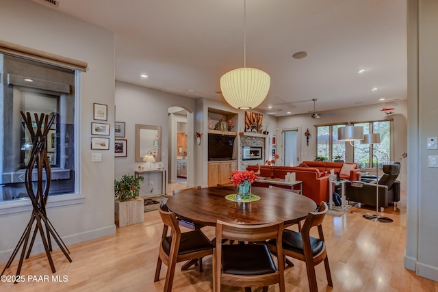 1690 Stable Rock Rd, Prescott, AZ 86303 - dining area featuring recessed lighting, arched walkways, a fireplace, and light wood-style flooring