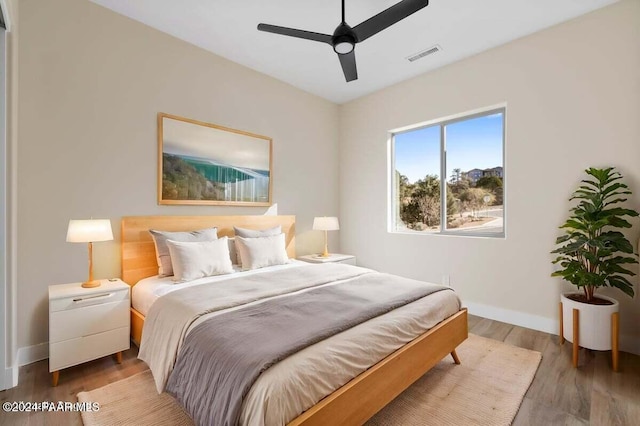 bedroom with ceiling fan and hardwood / wood-style flooring