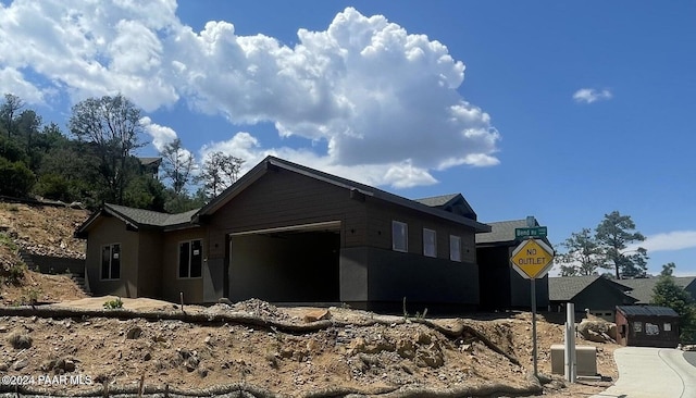 view of side of home featuring a garage