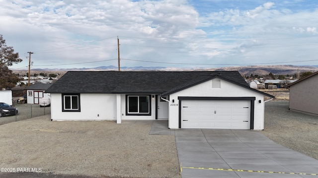 single story home with a mountain view and a garage