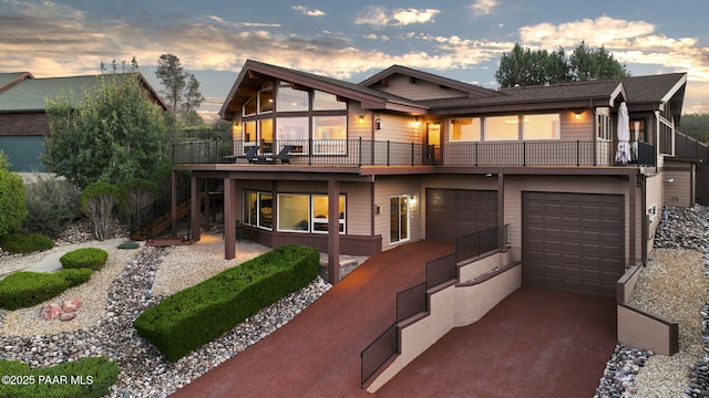 back house at dusk with a garage