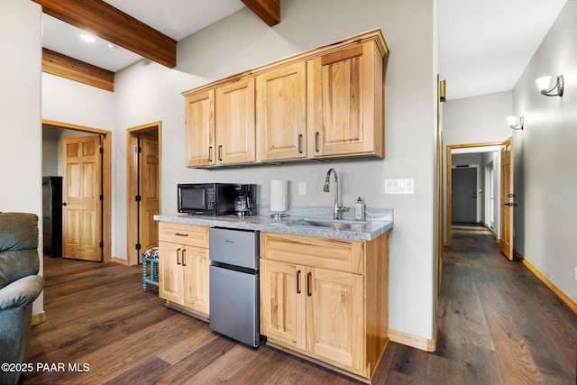 kitchen with light brown cabinets, fridge, dark hardwood / wood-style flooring, sink, and beam ceiling