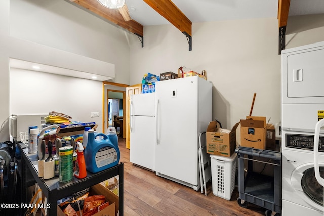 kitchen featuring white refrigerator, hardwood / wood-style floors, beamed ceiling, and stacked washer and dryer