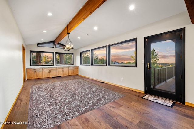 interior space featuring an inviting chandelier, vaulted ceiling with beams, and wood-type flooring