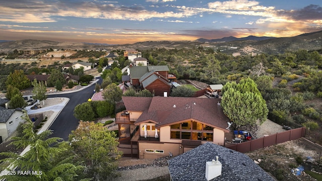 aerial view at dusk featuring a mountain view