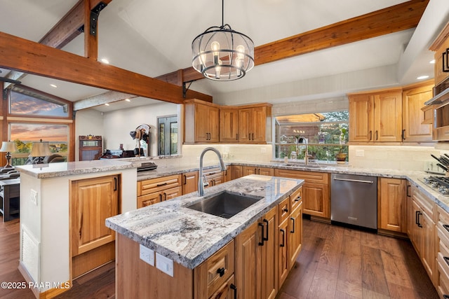 kitchen with appliances with stainless steel finishes, a kitchen island with sink, and sink