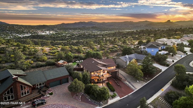 aerial view at dusk featuring a mountain view