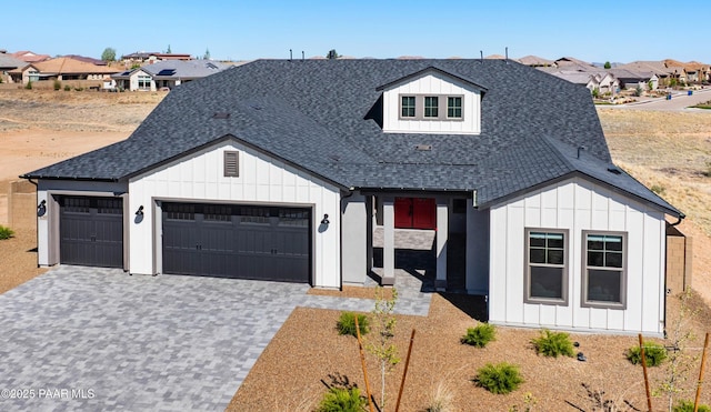 3290 Willow Butte Cir, Prescott, AZ 86301 - modern farmhouse featuring board and batten siding, a garage, a shingled roof, decorative driveway, and a residential view