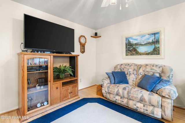 living room with baseboards and wood finished floors