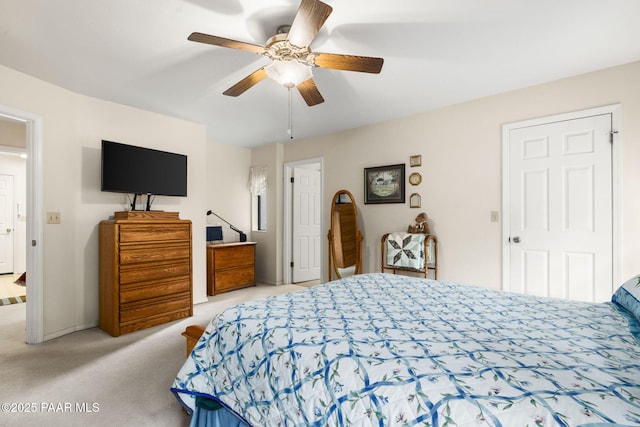 bedroom featuring light colored carpet and a ceiling fan