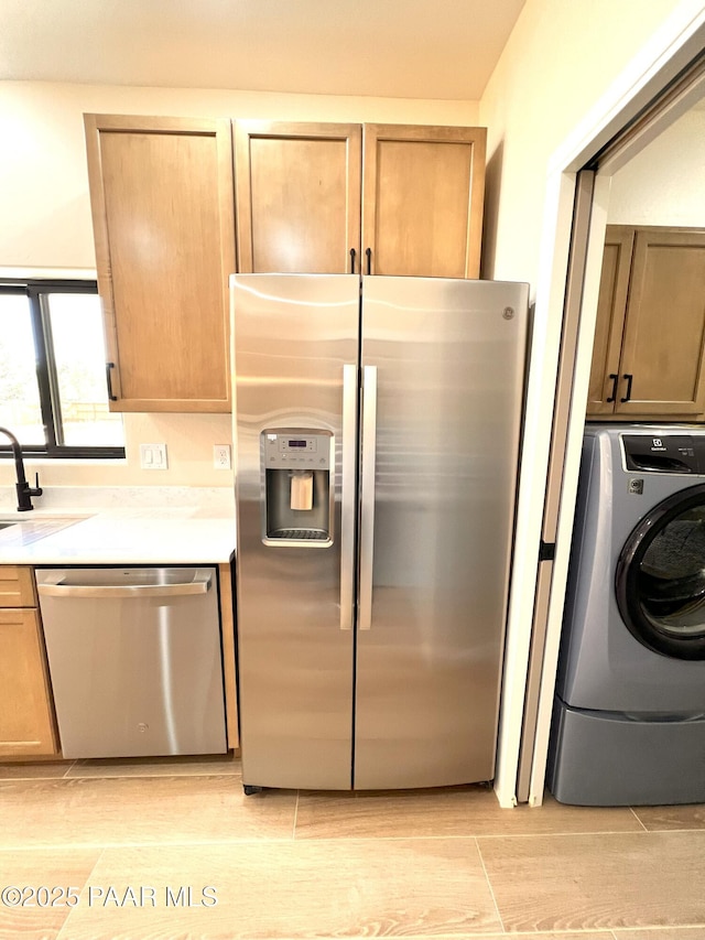 7010 N Race Track Rd, Prescott, AZ 86305 - kitchen featuring appliances with stainless steel finishes, washer / dryer, light countertops, and light wood-style floors