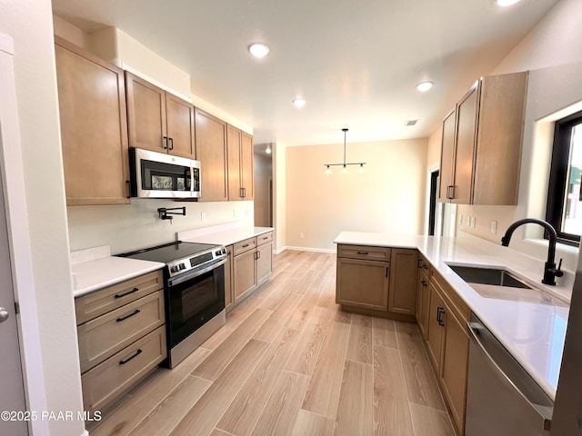 7010 N Race Track Rd, Prescott, AZ 86305 - kitchen featuring stainless steel appliances, a peninsula, recessed lighting, light countertops, and light wood-style floors