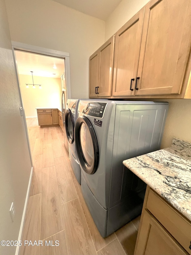 7010 N Race Track Rd, Prescott, AZ 86305 - laundry area featuring cabinet space, washer and clothes dryer, and light wood-style floors