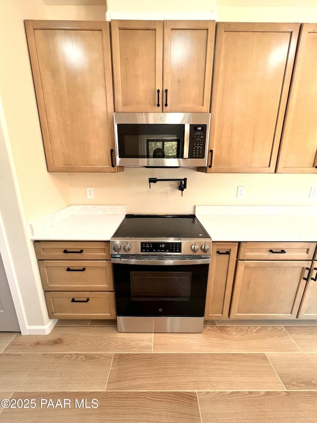 7010 N Race Track Rd, Prescott, AZ 86305 - kitchen with stainless steel appliances, wood tiled floors, and light countertops