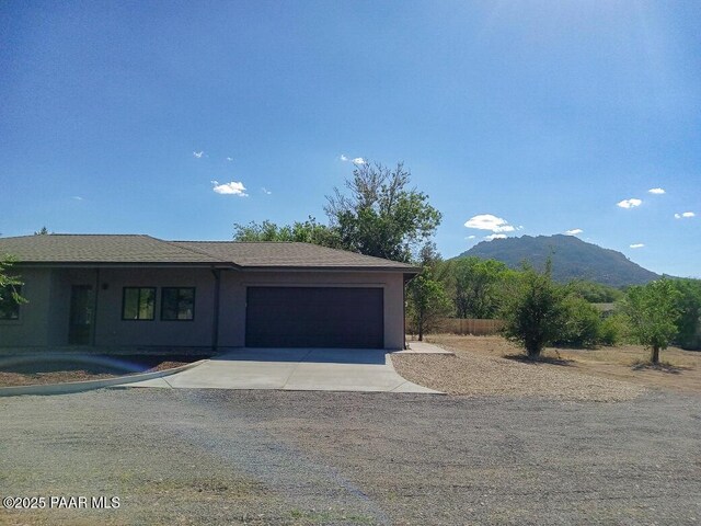 7010 N Race Track Rd, Prescott, AZ 86305 - view of front of property featuring an attached garage, a mountain view, and driveway