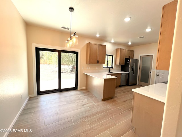 7010 N Race Track Rd, Prescott, AZ 86305 - kitchen with appliances with stainless steel finishes, a peninsula, light countertops, light wood finished floors, and recessed lighting