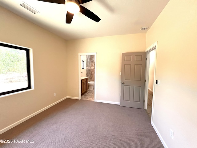7010 N Race Track Rd, Prescott, AZ 86305 - unfurnished bedroom with dark carpet, ensuite bath, and a ceiling fan