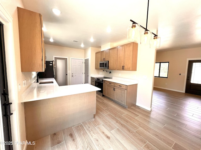 7010 N Race Track Rd, Prescott, AZ 86305 - kitchen featuring stainless steel appliances, light wood-style floors, light countertops, a peninsula, and recessed lighting