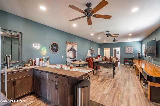 4995 Cactus Pl, Prescott, AZ 86301 - kitchen featuring a sink, a ceiling fan, butcher block countertops, light wood-style flooring, and dark brown cabinetry