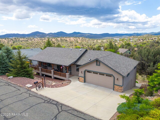 4995 Cactus Pl, Prescott, AZ 86301 - ranch-style house featuring a garage, stucco siding, a mountain view, stone siding, and driveway