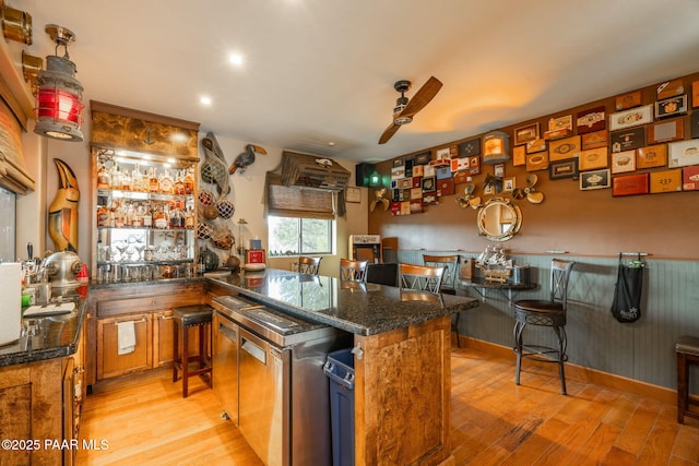 4995 Cactus Pl, Prescott, AZ 86301 - kitchen with ceiling fan, light wood-style floors, dark stone countertops, a peninsula, and recessed lighting