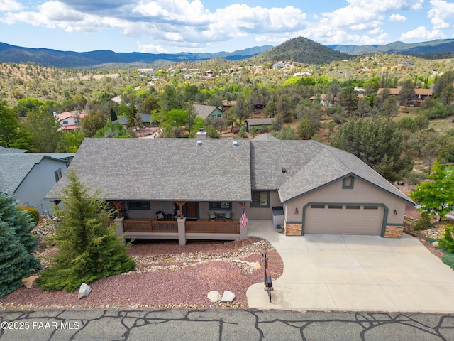 4995 Cactus Pl, Prescott, AZ 86301 - view of front of home featuring stone siding, a garage, a mountain view, stucco siding, and driveway