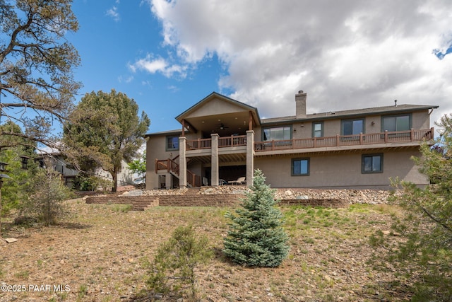 4995 Cactus Pl, Prescott, AZ 86301 - back of house featuring ceiling fan, stairs, a chimney, and stucco siding