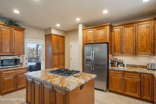 4995 Cactus Pl, Prescott, AZ 86301 - kitchen featuring appliances with stainless steel finishes, brown cabinets, light stone counters, and recessed lighting