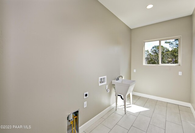 12214 N Petra Cir, Prescott, AZ 86305 - clothes washing area with electric dryer hookup, washer hookup, baseboards, light tile patterned flooring, and recessed lighting