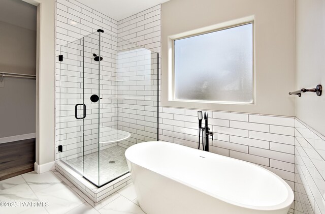 12214 N Petra Cir, Prescott, AZ 86305 - bathroom featuring a stall shower, a soaking tub, tile walls, and marble look tiles