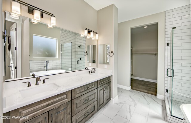 12214 N Petra Cir, Prescott, AZ 86305 - bathroom with a shower stall, double vanity, marble look tiles, a freestanding tub, and baseboards