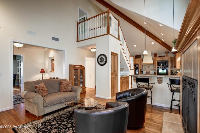 205 S Arizona Ave, Prescott, AZ 86303 - bedroom featuring wood finished floors, baseboards, visible vents, and ensuite bath