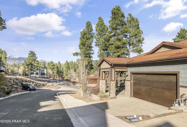 view of front of home featuring a mountain view and a garage