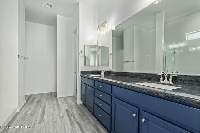 bathroom featuring vanity, hardwood / wood-style flooring, and walk in shower